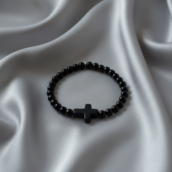 Embrace timeless simplicity with the Notte Nera bracelet, a unisex piece designed for those who value quiet strength and deep purpose. Handcrafted with polished black onyx beads and centered by a bold matte cross, this bracelet represents resilience, faith, and unwavering character. Its minimalist design makes it perfect for everyday wear—whether styled alone or stacked with other pieces. A reminder that true power speaks softly.