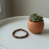 Inspired by the warm tones of the earth, the Terra Rosa bracelet is a tribute to natural beauty and inner strength. Handcrafted with polished Red Jasper gemstones, each bead carries unique patterns and grounding energy. Simple yet captivating, this piece complements both everyday style and quiet moments of reflection. A symbol of stability, courage, and feminine resilience, Terra Rosa is more than jewelry—it's a meaningful companion.