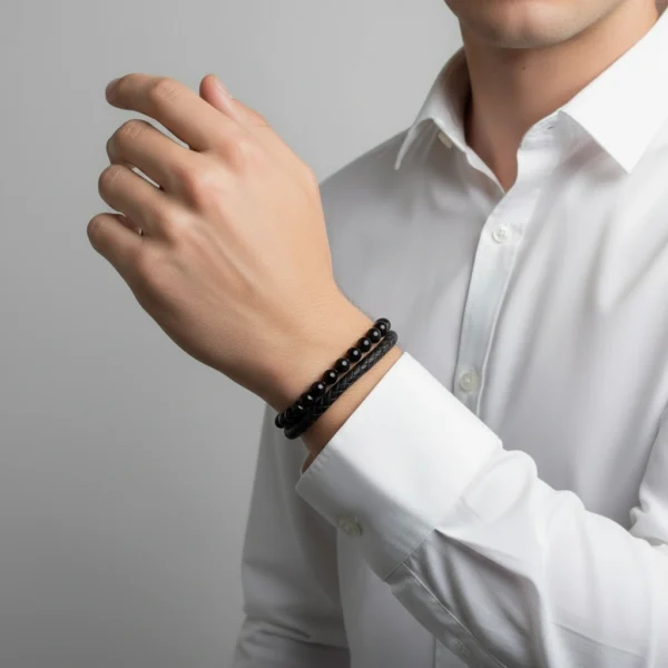 Meet the Nero Elite Bracelet, the embodiment of modern masculine elegance. Featuring a dual design of braided genuine leather and polished black onyx beads, this bracelet delivers a bold yet refined statement. The secure stainless steel magnetic clasp ensures durability and ease of wear, making it the perfect companion for both business attire and casual looks. Designed for men who appreciate timeless style and subtle sophistication, Nero Elite is more than an accessory—it's a signature.