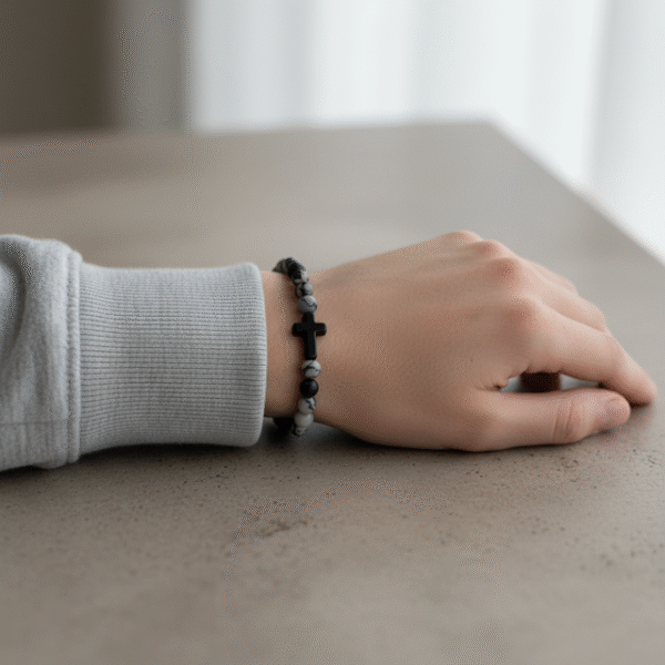 Discover refined faith with the Pietra di Fede bracelet. Designed for the modern man, this piece blends natural stone beads in bold shades of black, grey, and earthy tones with a sleek cross centerpiece. Each bead is uniquely patterned, making every bracelet one of a kind. Wear it as a daily reminder of direction, purpose, and grounded strength. Built on durable stretch cord for all-day comfort—casual enough for everyday wear, meaningful enough for moments that matter.