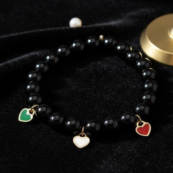 Carry a piece of Italy with you—wherever life takes you. The Cuore d’Italia bracelet is a timeless tribute to heritage, passion, and love. Handcrafted with polished black onyx stones for strength and grounding, this elegant bracelet features three gold plated enamel heart charms in the colors of the Italian flag—green, white, and red—each gold-plated for a luxurious touch. Perfect for those who cherish their Italian roots or simply admire the beauty and soul of Italian culture. Stack it, gift it, or wear it as a daily reminder that love knows no distance.