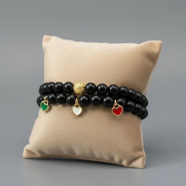 Carry a piece of Italy with you—wherever life takes you. The Cuore d’Italia bracelet is a timeless tribute to heritage, passion, and love. Handcrafted with polished black onyx stones for strength and grounding, this elegant bracelet features three gold plated enamel heart charms in the colors of the Italian flag—green, white, and red—each gold-plated for a luxurious touch. Perfect for those who cherish their Italian roots or simply admire the beauty and soul of Italian culture. Stack it, gift it, or wear it as a daily reminder that love knows no distance.