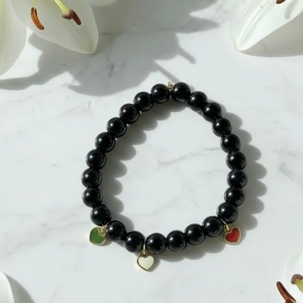 Carry a piece of Italy with you—wherever life takes you. The Cuore d’Italia bracelet is a timeless tribute to heritage, passion, and love. Handcrafted with polished black onyx stones for strength and grounding, this elegant bracelet features three gold plated enamel heart charms in the colors of the Italian flag—green, white, and red—each gold-plated for a luxurious touch. Perfect for those who cherish their Italian roots or simply admire the beauty and soul of Italian culture. Stack it, gift it, or wear it as a daily reminder that love knows no distance.