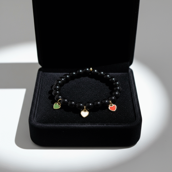 Carry a piece of Italy with you—wherever life takes you. The Cuore d’Italia bracelet is a timeless tribute to heritage, passion, and love. Handcrafted with polished black onyx stones for strength and grounding, this elegant bracelet features three gold plated enamel heart charms in the colors of the Italian flag—green, white, and red—each gold-plated for a luxurious touch. Perfect for those who cherish their Italian roots or simply admire the beauty and soul of Italian culture. Stack it, gift it, or wear it as a daily reminder that love knows no distance.