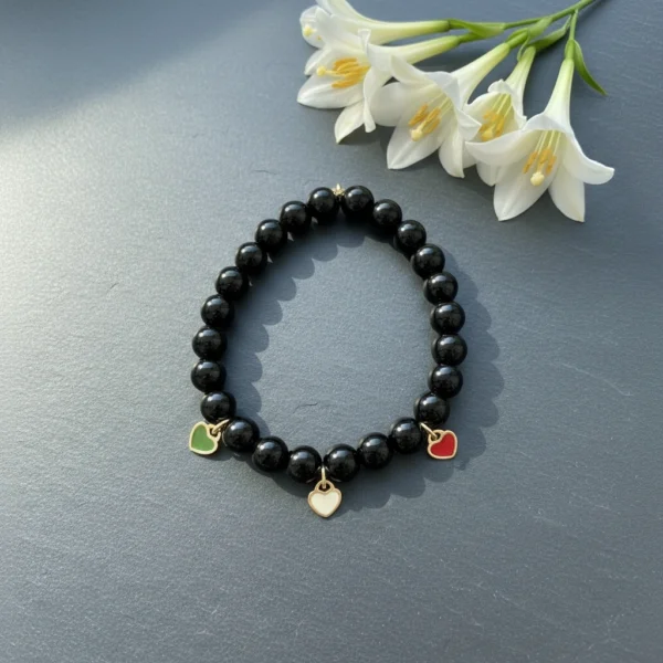 Carry a piece of Italy with you—wherever life takes you. The Cuore d’Italia bracelet is a timeless tribute to heritage, passion, and love. Handcrafted with polished black onyx stones for strength and grounding, this elegant bracelet features three gold plated enamel heart charms in the colors of the Italian flag—green, white, and red—each gold-plated for a luxurious touch. Perfect for those who cherish their Italian roots or simply admire the beauty and soul of Italian culture. Stack it, gift it, or wear it as a daily reminder that love knows no distance.