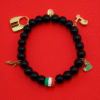 Celebrate your passion, personality, and Italian soul with Spirito Libero. This luxurious charm bracelet blends modern style with Italian heritage for a bold, expressive statement. Designed using polished black onyx beads—known for strength and grounding—it features premium gold-plated charms that tell a story of freedom, adventure, and unmistakable Italian flair. From the tricolor bead symbolizing Italia to unique charms like the Vespa scooter, stiletto heel, heart, and luxury handbag, every detail reflects la dolce vita—confidence, romance, and passion for life. Whether you're elevating your everyday style or honoring your roots, this bracelet is a masterpiece of personality.