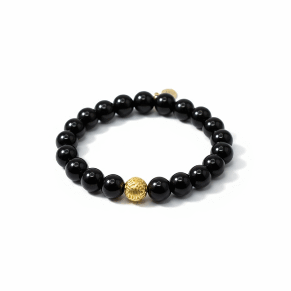 Bold. Refined. Unapologetically powerful. The Nero Reale bracelet blends minimalist luxury with timeless Italian elegance. Handcrafted using premium polished black onyx beads—known for their grounding energy and inner strength—this piece features a single 24k gold-plated accent bead as a symbol of purpose and prestige. A tribute to quiet confidence, this bracelet is made for those who lead by presence, not noise. Whether worn alone or stacked, Nero Reale delivers elevated style for every moment—from boardroom to night out.