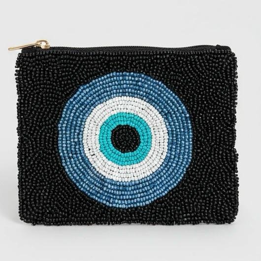 "Notte Occhio Pouch "  Where Chic Meets Protection. The Notte Occhio beaded pouch, a striking accessory designed to keep you stylish and protected. Hand-embellished with thousands of jet-black beads and a vibrant layered evil-eye motif, this pouch blends modern chic with ancient symbolism.   Fully lined with soft interior fabric, and zip closure with gold-toned hardware. Dimensions: 5" x 4" Perfect as a jewelry pouch, or coin purse, this artisanal piece embodies craftsmanship and meaning. Every bead reflects light, symbolizing resilience, clarity, and confidence.