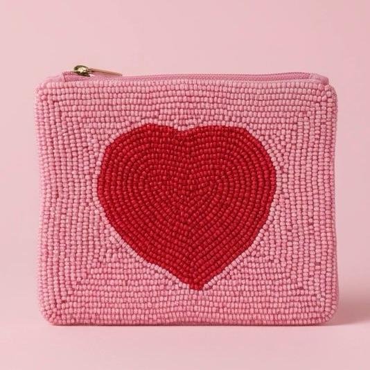 "Cuore Rosa Pouch "  Where Love Lives in Color. Cuore Rosa beaded pouch celebrates love in its sweetest form. Hand-beaded with thousands of soft pink and vibrant red glass beads. Its bold heart motif brings joy and intention to every moment.   Fully lined with soft interior fabric, and zip closure with gold-toned hardware. Dimensions: 5" x 4" Perfect as a jewelry pouch, or coin purse, this artisanal piece embodies craftsmanship and meaning. Every bead reflects light, symbolizing resilience, clarity, and confidence.