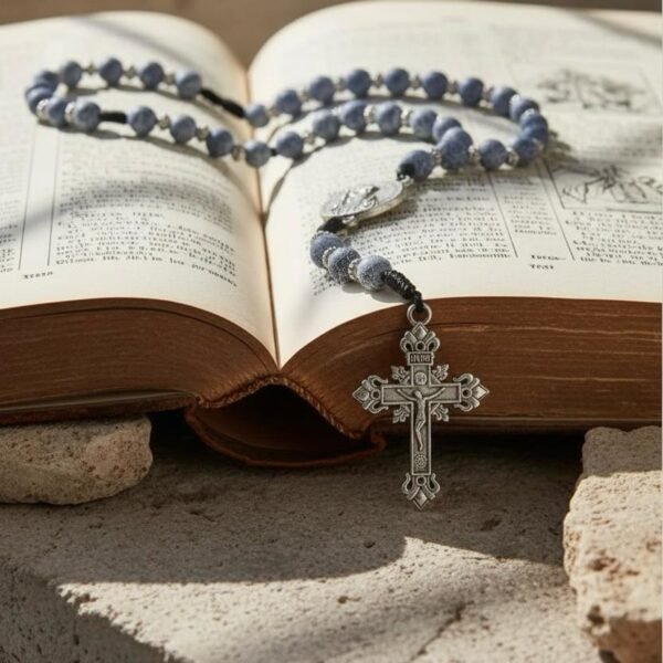 "Rosario di San Benedetto" Strength, Protection & Sacred Peace. The Rosario di San Benedetto is a powerful symbol of faith and protection, crafted for those who seek strength, guidance, and spiritual grounding. Featuring stunning blue crackle beads, hand-woven cord detailing, and an ornate crucifix, this rosary is anchored by the revered Saint Benedict medal — known for its centuries-old symbolism of protection against negativity and harm. Each bead offers a moment of peace, each prayer a step closer to clarity, comfort, and spiritual connection. Beautifully detailed and intentionally designed, this rosary makes a meaningful gift for yourself or someone you love. A timeless devotional piece to carry with you through every challenge, every blessing, and every prayer.