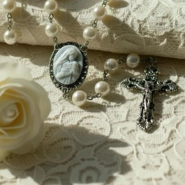 "Cameo Rosary – Mother’s Kiss" A tender devotion, beautifully preserved. The Cameo Rosary – Mother’s Kiss is a timeless, elegant piece crafted for those who cherish faith, love, and the gentle bond between mother and child. Featuring luminous pearl-style beads and an intricately detailed cameo centerpiece, this rosary beautifully portrays Mary cradling the infant Jesus — a symbol of unconditional love, nurturing, and divine protection. The antique-inspired crucifix adds a touch of classic reverence, making this rosary both a meaningful devotional tool and a cherished keepsake. Whether prayed with daily or gifted to someone special, Mother’s Kiss is a heartfelt reminder of comfort, guidance, and grace. Perfect for Mother’s Day, baptisms, confirmations, memorial gifts, or anyone seeking a rosary that celebrates both faith and maternal love.