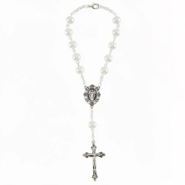 "Stella Bianca" A Guardian of Grace for Every Journey. Bring peace, protection, and beauty to every drive with the Stella Bianca Car Rosary. Designed with luminous white pearl-style beads and an intricately detailed Miraculous Medal centerpiece, this rosary is made specifically to hang from your rearview mirror, offering a gentle reminder of faith wherever the road takes you. The silver crucifix and classic oval devotional medal add a timeless touch, making this piece both meaningful and elegant. Whether used as a symbol of protection or given as a thoughtful gift, Stella Bianca is perfect for daily commuters, new drivers, and anyone who feels comfort in having their faith close by. A simple way to carry grace, guidance, and serenity with you on every journey.