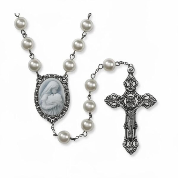 "Cameo Rosary – Mother’s Kiss" A tender devotion, beautifully preserved. The Cameo Rosary – Mother’s Kiss is a timeless, elegant piece crafted for those who cherish faith, love, and the gentle bond between mother and child. Featuring luminous pearl-style beads and an intricately detailed cameo centerpiece, this rosary beautifully portrays Mary cradling the infant Jesus — a symbol of unconditional love, nurturing, and divine protection. The antique-inspired crucifix adds a touch of classic reverence, making this rosary both a meaningful devotional tool and a cherished keepsake. Whether prayed with daily or gifted to someone special, Mother’s Kiss is a heartfelt reminder of comfort, guidance, and grace. Perfect for Mother’s Day, baptisms, confirmations, memorial gifts, or anyone seeking a rosary that celebrates both faith and maternal love.