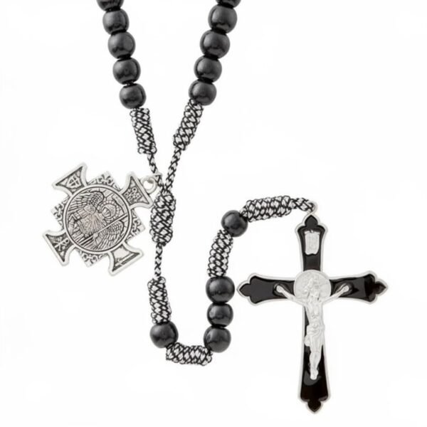 "Rosario di San Michele" Strength, courage, and divine protection. The Rosario di San Michele is a powerful symbol of faith, courage, and heavenly protection. Designed with deep black prayer beads, durable woven cord, and a striking silver-tone St. Michael medallion, this rosary honors the Defender of Heaven—protector against harm, fear, and darkness. A bold black-and-silver crucifix completes the design, creating a meaningful devotional piece for daily prayer, meditation, or spiritual grounding. Whether kept close during life’s hardest battles or gifted to someone in need of strength, this rosary serves as a reminder that you never walk alone—Saint Michael walks beside you. Perfect for men, women, and teens seeking a strong, traditional, and beautifully crafted rosary.