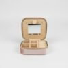 Grazia da Viaggio Organizer “Elegance that travels with you.” Meet Grazia da Viaggio Organizer, your new must-have travel companion for keeping jewelry beautifully organized wherever life takes you. Crafted in soft blush velvet with a luxe satin finish, this compact organizer opens to reveal a smart, multi-section interior: divided compartments for earrings and pendants, cushioned ring slots, and a built-in mirror for effortless touch-ups on the go. The secure zip-around closure protects your favorite pieces from tangles and scratches, while the lightweight design makes it perfect for handbags, carry-ons, gym bags, or weekend trips. Practical, pretty, and travel-ready — Grazia da Viaggio Organizer brings effortless elegance to every journey. Dimensions: 3.93" × 1.96" Features: Ring rolls, earrings slots, multi-use open compartments, built-in mirror, secure zipper