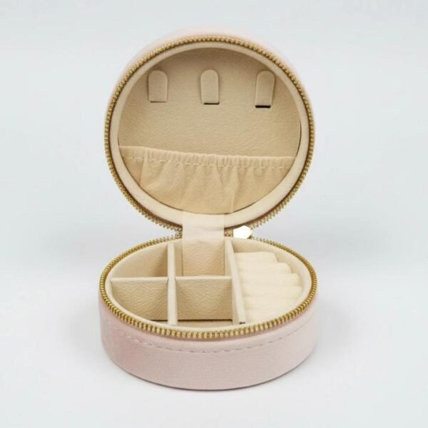 Cerchio di Lusso Organizer  “Circle of Luxury” Meet the Cerchio di Lusso Organizer, your chic and compact solution for keeping jewelry safe, sorted, and beautifully stored—wherever life takes you. Designed in a soft velvet-touch exterior with a smooth, rounded silhouette, this travel-friendly case blends luxury with practicality. Inside, plush compartments protect your favorite rings, earrings, necklaces, and bracelets, while a secure zipper closure ensures everything stays perfectly in place. Its structured dividers, ring rolls, and small pocket make it effortless to carry multiple pieces without tangles or damage. Perfect for travel, gifting, or elevating your everyday organization, the Cerchio di Lusso Organizer brings Italian-inspired elegance to your jewelry collection. Dimensions: 3.93" x 1.96"  Features: Ring rolls, divided compartments, elastic pocket, secure zipper