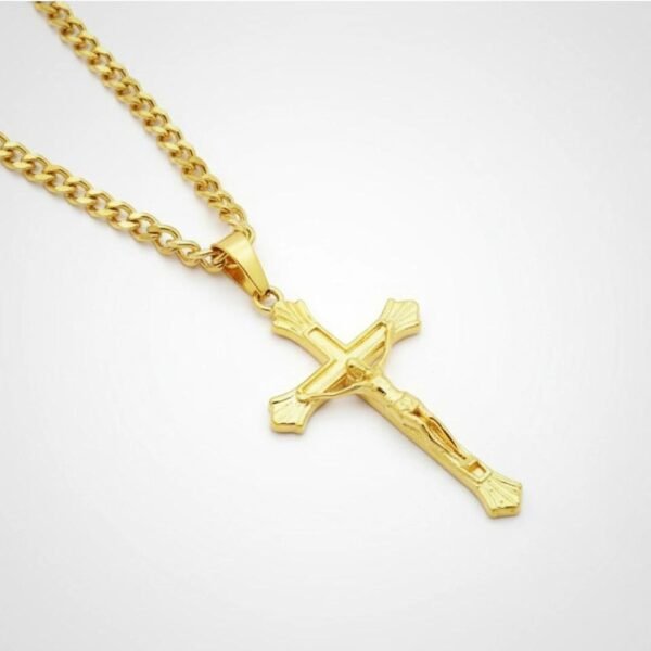 "Crocefisso Dorato Classico" A timeless symbol of faith and devotion. The Crocefisso Dorato Classico is designed for those who cherish both tradition and beauty. This gold-toned crucifix features intricate detailing and a radiant polished finish, capturing the sacred symbolism of the crucifix in an elegant, wearable form. Suspended from a 24-inch gold-toned curb chain, it offers durability, comfort, and a refined look that transitions seamlessly from daily wear to special occasions. A meaningful gift of devotion, strength, and grace.