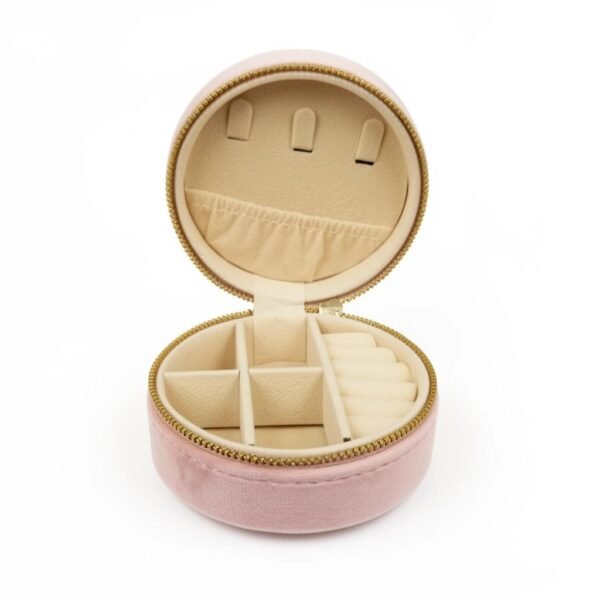 "Cerchio di Lusso " Circle of Luxury. Meet the Cerchio di Lusso Organizer, your chic and compact solution for keeping jewelry safe, sorted, and beautifully stored—wherever life takes you. Designed in a soft velvet-touch exterior with a smooth, rounded silhouette, this travel-friendly case blends luxury with practicality. Inside, plush compartments protect your favorite rings, earrings, necklaces, and bracelets, while a secure zipper closure ensures everything stays perfectly in place. Its structured dividers, ring rolls, and small pocket make it effortless to carry multiple pieces without tangles or damage. Perfect for travel, gifting, or elevating your everyday organization, the Cerchio di Lusso Organizer brings Italian-inspired elegance to your jewelry collection. Dimensions: 3.93" x 1.96" Features: Ring rolls, divided compartments, elastic pocket, secure zipper