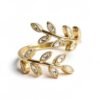 "Alloro" A timeless symbol of victory, honor and eternal Italian elegance. The Alloro ring embrace Italian elegance with this gold-plated wrap ring, featuring two graceful olive branches adorned with sparkling accents. Timeless, delicate, and effortlessly chic. A perfect piece for layering or wearing solo, this ring embodies effortless glamour and everyday versatility. Designed to be worn casually or styled for impact, the Alloro ring blends timeless natural beauty with refined, radiant sparkle.