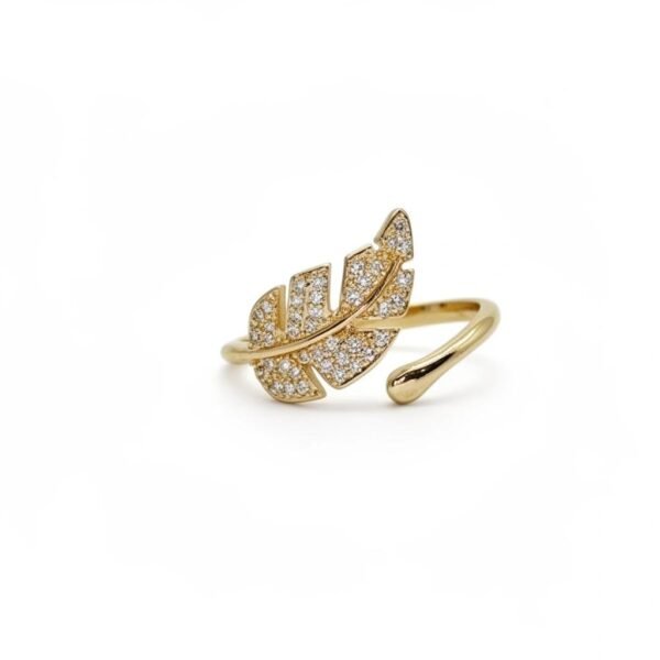 "Foglia Dorata" Nature’s elegance, reimagined in gold. The Foglia Dorata ring captures the delicate beauty of nature in a fashion-forward design. Crafted in gold-plated brass, this adjustable ring showcases a sparkling pavé crystal leaf that wraps gracefully around your finger. Its open band ensures a comfortable fit while adding a touch of modern sophistication. A perfect piece for layering or wearing solo, this ring embodies effortless glamour and everyday versatility. Whether worn casually or as a statement accessory, the Foglia Dorata Ring is a timeless expression of natural beauty elevated with radiant sparkle.