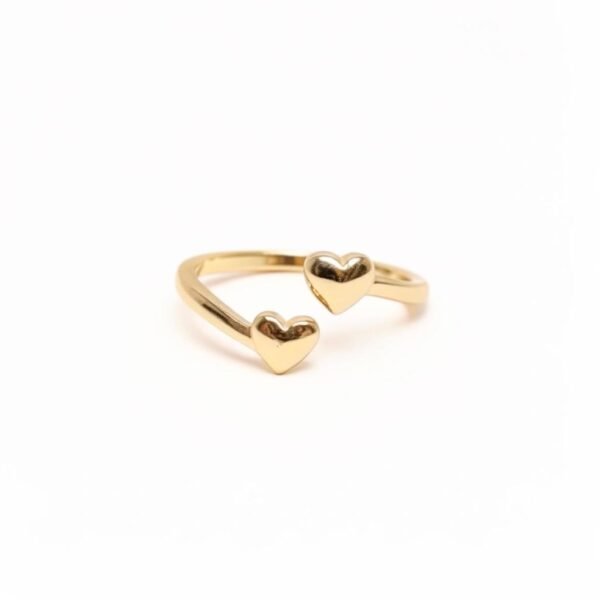 "Cuori Insieme" Two hearts, one faith. The Cuori Insieme ring beautifully symbolizes the strength of connection bound by love and faith. Two polished gold-plated hearts unite in an open design, representing the unbreakable bond shared between loved ones and the guiding light of faith that strengthens it. The open design also allows the ring to be adjustable, letting you switch between fingers depending on your style of the day—making it as versatile as it is meaningful. Simple yet deeply meaningful, this piece is a reminder that love grows stronger when rooted in faith—making it a cherished everyday accessory or a heartfelt gift.