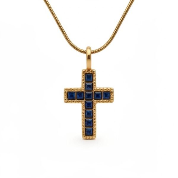 "Della Sapienza" Faith guided by wisdom. The Della Sapienza Necklace is a timeless expression of faith, clarity, and inner strength. Crafted in radiant gold plating, this elegant cross pendant is adorned with deep sapphire-blue stones, long associated with wisdom, truth, and spiritual insight. Each stone is set within a textured gold frame, creating a striking balance of richness and refinement. The luminous blue tones evoke serenity and depth, while the classic cross silhouette honors enduring devotion. Designed to be worn close to the heart, Della Sapienza transitions effortlessly from everyday wear to meaningful moments. A powerful symbol of faith and understanding, it is a beautiful reminder that wisdom and devotion walk hand in hand.